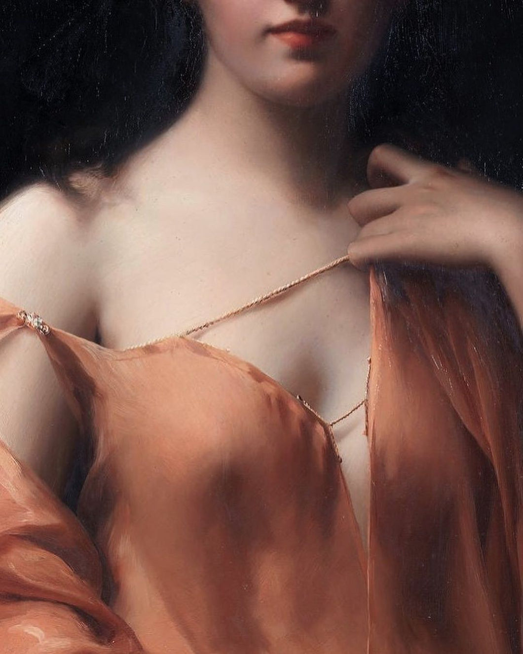 A light skinned woman with dark hair wearing a diaphanous orange silken gown delicately loosens a tie to reveal the smooth expanse of her shoulder and the curved top of her breast.